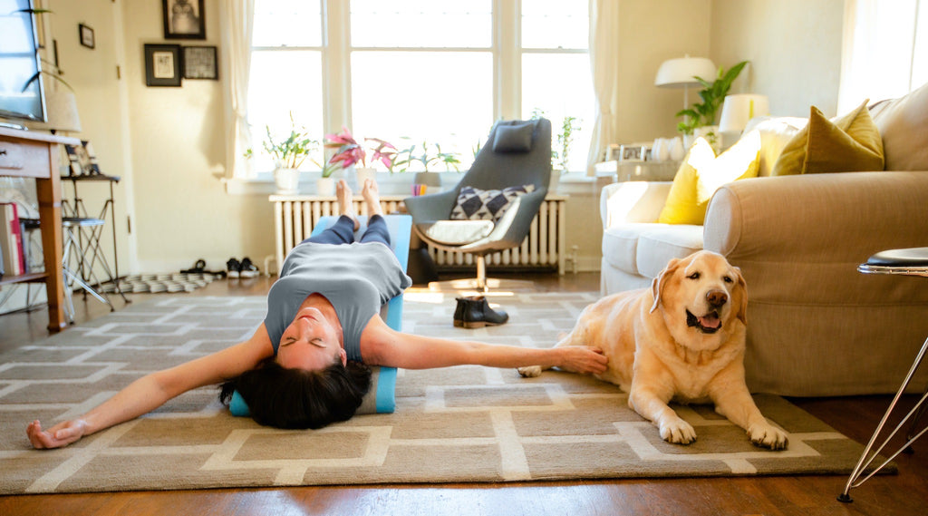 Woman lying back on Lull, a gentle inversion board for relaxation and health.
